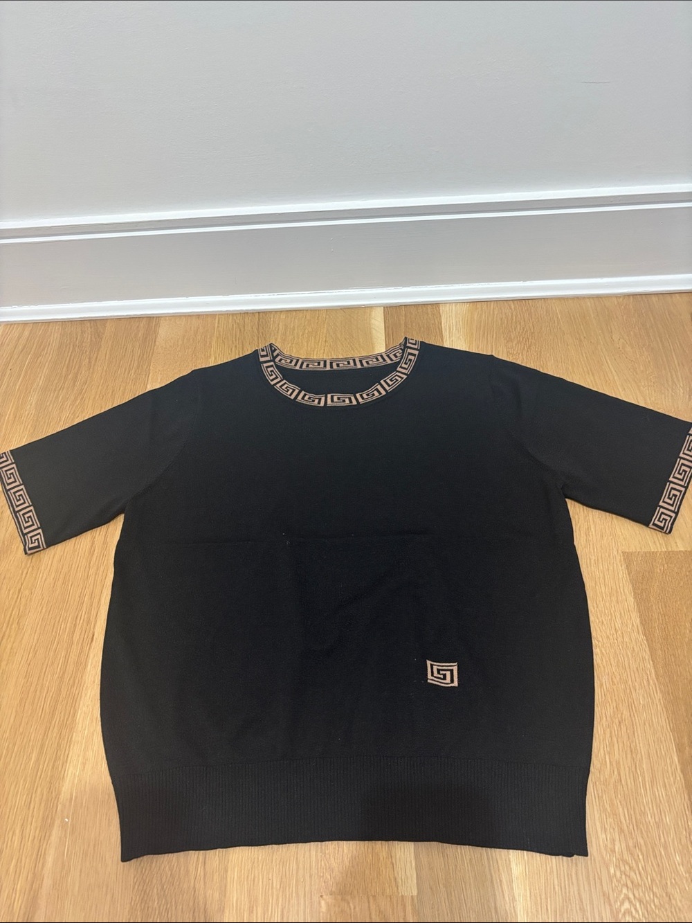 Black Woman Short-Sleeve Top with Geometric Trim